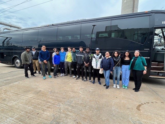 Stem club students standing in front of the bus.